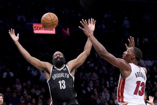 James Harden of the Brooklyn Nets loses the ball while driving to the basket against the Miami Heat's Bam Adebayo.