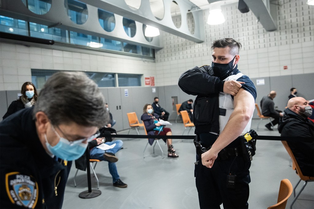 A member of the New York Police Department gets vaccinated