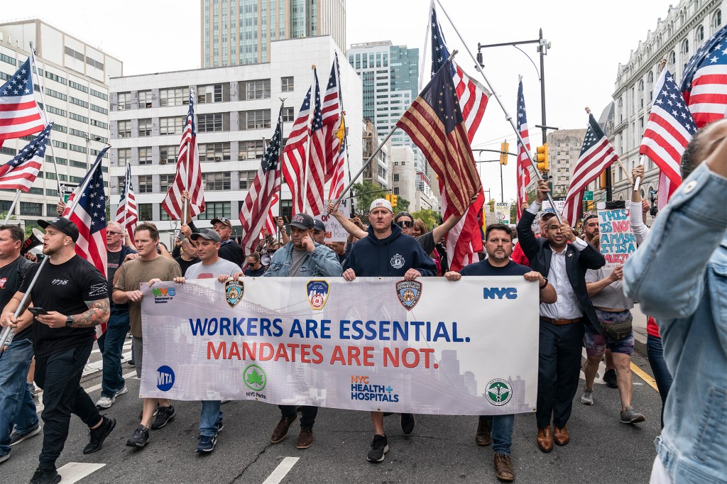 Municipal workers of the city march across Brooklyn bridge and rally at City Hall Park against vaccination mandate