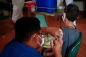 A child receives a dose of the Pfizer-BioNTech coronavirus disease (COVID-19) vaccine