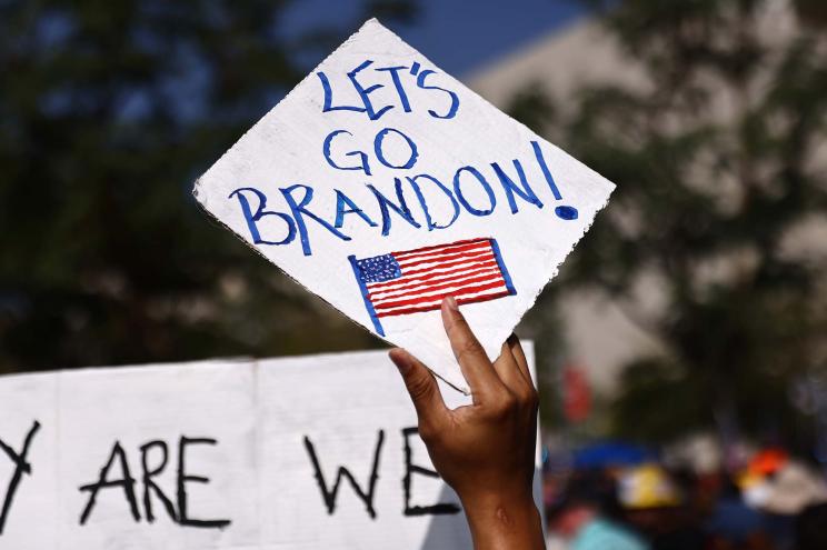 A protester holds a 'Let's Go Brandon!' sign in Grand Park at a rally in Los Angeles, California.