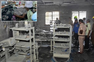 People inspect a hospital's COVID-19 ward that caught fire in Ahmednagar