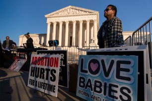 People holding pro-life signs at the Supreme Court on November 30, 2021. The court will be ruling on a controversial Mississippi abortion law.