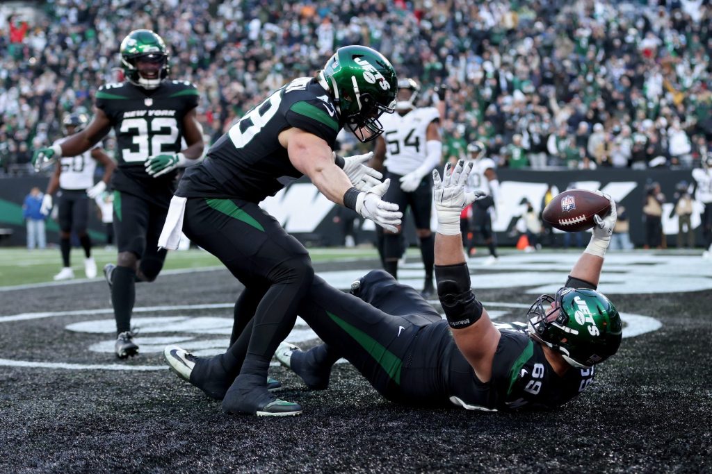 Jets lineman Conor McDermott celebrates a touchdown with Nick Bawden during the fourth quarter of a game against the Jaguars at MetLife Stadium on Dec. 26, 2021 in East Rutherford, New Jersey.