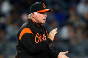 Buck Showalter #26 of the Baltimore Orioles makes a pitching change against the New York Yankees on April 6, 2018.