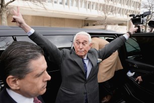 Roger Stone gestures as he leaves the O'Neill House Office Building, following his deposition before the House Select Committee investigating the January 6 attack on the U.S. Capitol