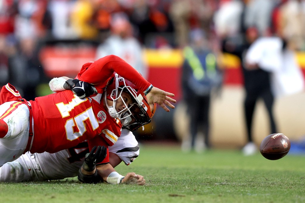 Bengals defensive end Sam Hubbard forces a fumble as he sacks Chiefs quarterback Patrick Mahomes late in the fourth quarter of the AFC Championship Game at Arrowhead Stadium on Jan. 30, 2022 in Kansas City, Missouri.