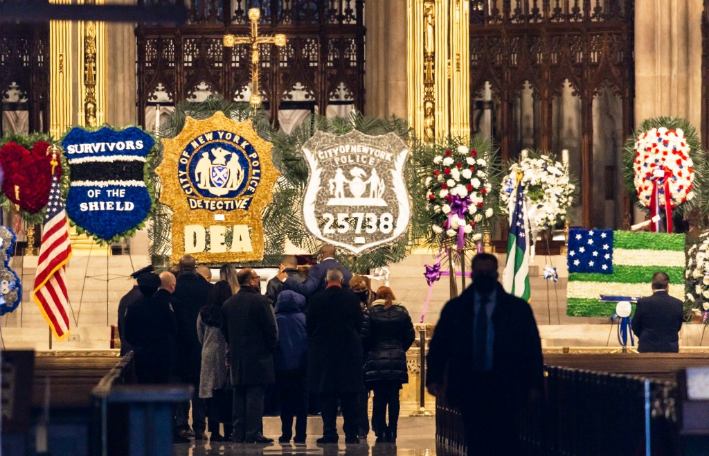 Family members gather at the casket of slain New York City police officer Jason Rivera in St. Patrick’s Cathedral.