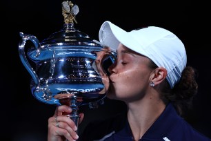 Ashleigh Barty of Australia kisses the Daphne Akhurst Memorial Cup after defeating Danielle Collins in the women’s singles final at the Australian Open on Jan. 29, 2022.