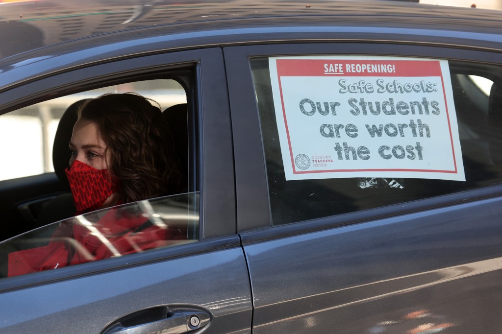 Members of the Chicago Teachers Union and their supporters participate in a car caravan around City Hall to protest against in-person learning in Chicago public schools 