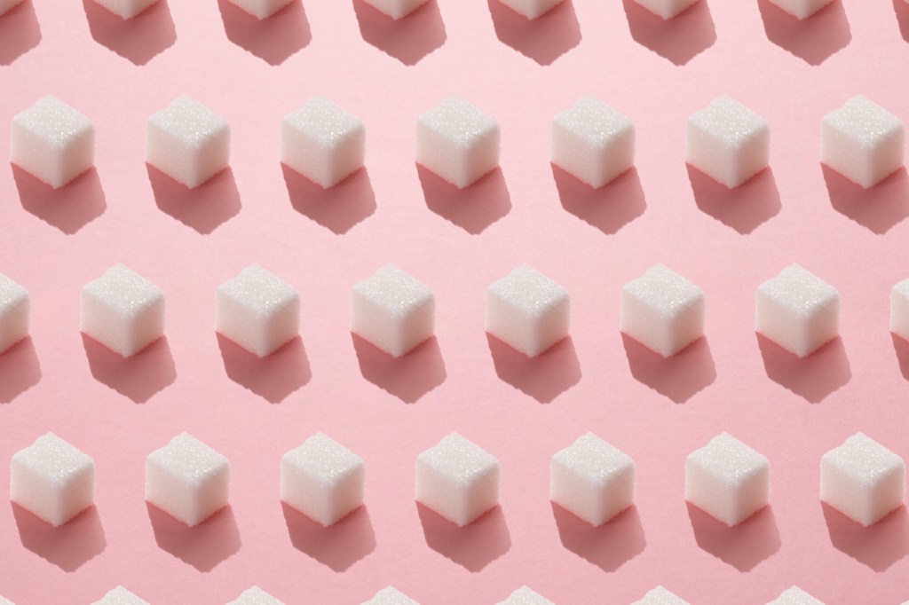 Sugar cubes on pink background.