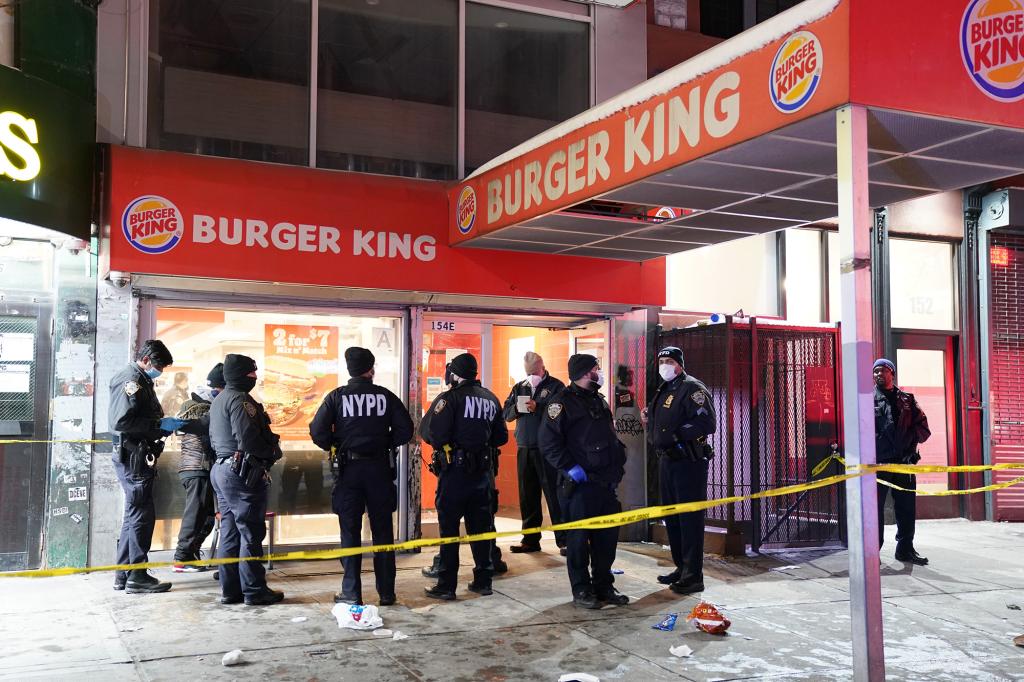 Police at the scene where a female employee was possibly fatally shot during a robbery of the Burger King restaurant located at 154 E116th Street