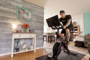 BRICK, NEW JERSEY - APRIL 16: Brody Longo works out on his Peloton exercise bike on April 16, 2021 in Brick, New Jersey. There is a competitive business war between indoor connected fitness devices fueled by quarantine life due to COVID-19. (Photo by Michael Loccisano/Getty Images)