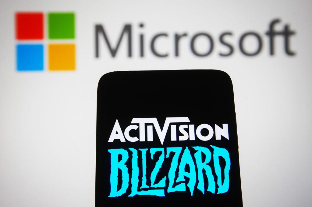 this photo illustration, the Activision Blizzard logo is seen displayed on a smartphone screen with the Microsoft Corporation logo