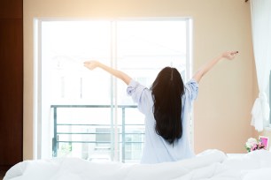 A woman stretches as she wakes up.