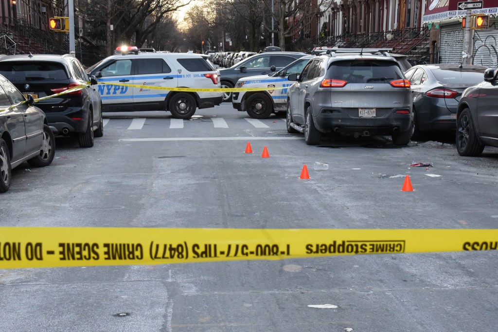 Police investigating the scene of the fatal shooting in Brooklyn.