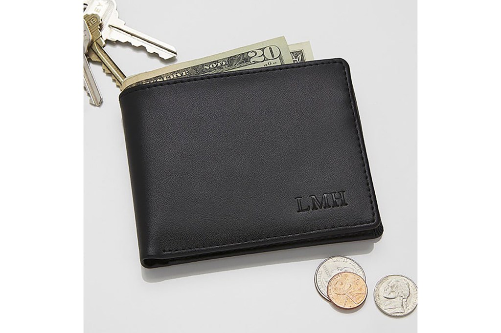 A black wallet with initials engraved in the corner 