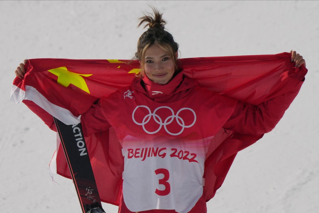 Eileen Gu celebrates with the Chinese flag. 