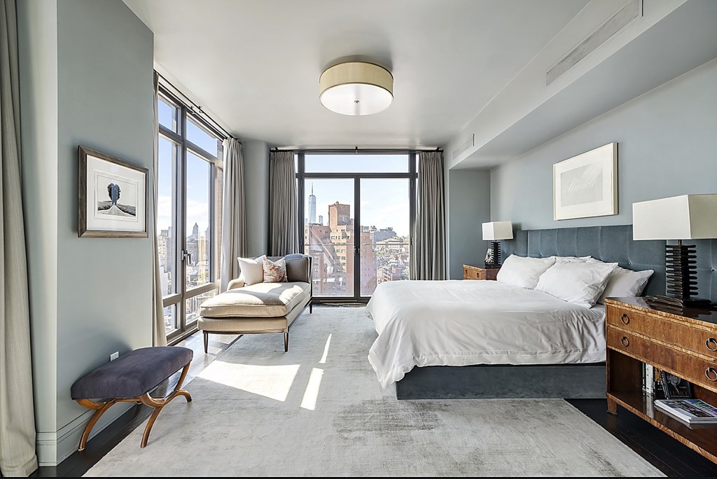 The condo's bedroom suite at Jon Bon Jovi's apartment features a walk-in closet and a windowed marble bathroom, as views from the south and the east can be seen.