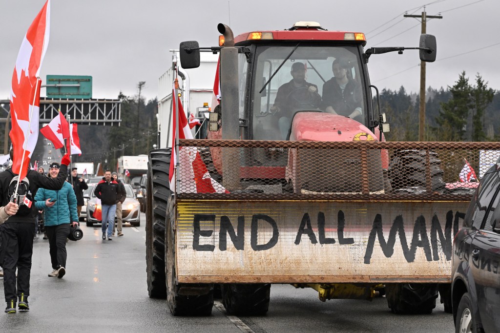 A tractor is seen in a convoy of vehicles and supporters gathered near the border as they continue to protest against COVID-19 mandates in Canada on February 19, 2022.