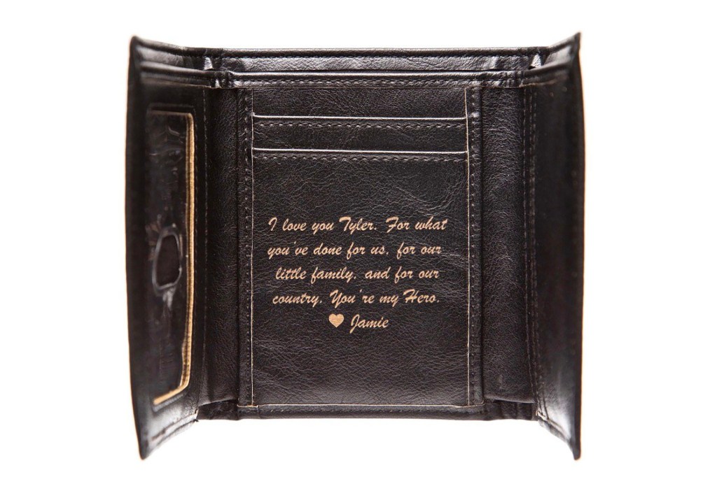 A brown wallet with a message engraved 