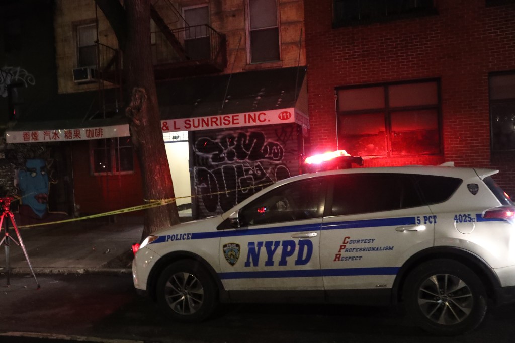 Flowers and Police at the scene of a homicide at 111 Chrystie St.