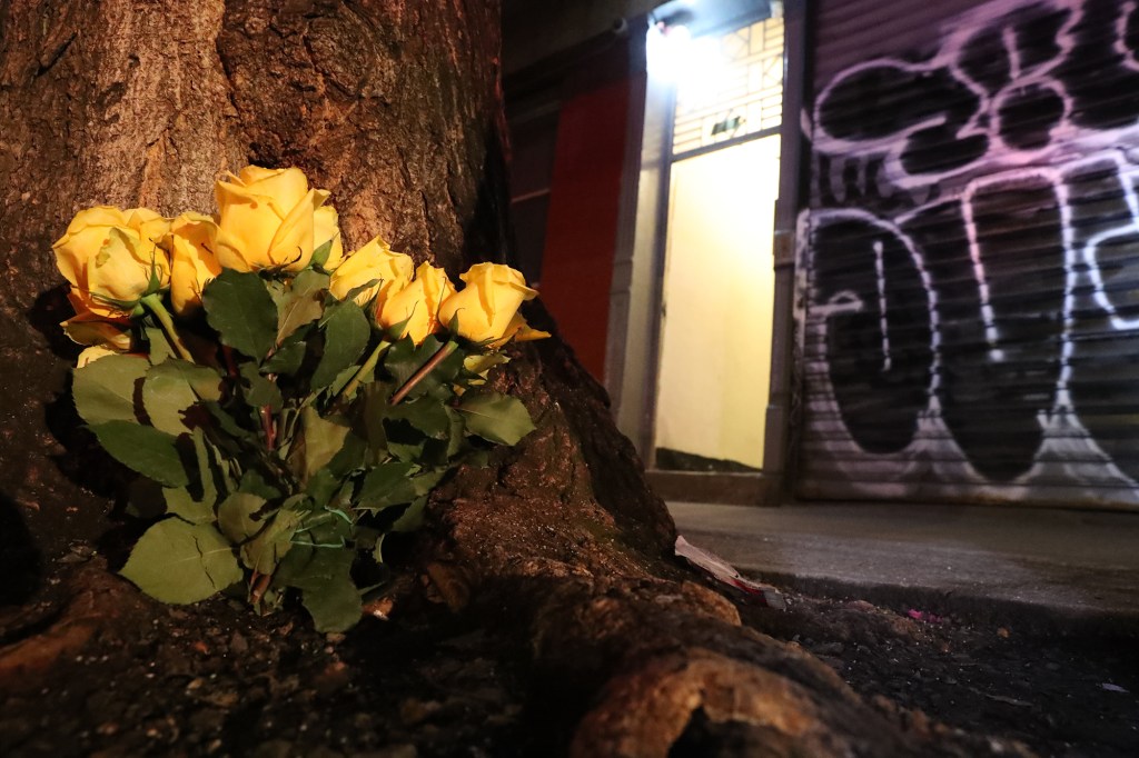 Flowers and Police at the scene of a homicide at 111 Chrystie St.
