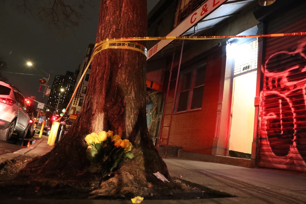 Flowers and Police at the scene of a homicide at 111 Chrystie St.