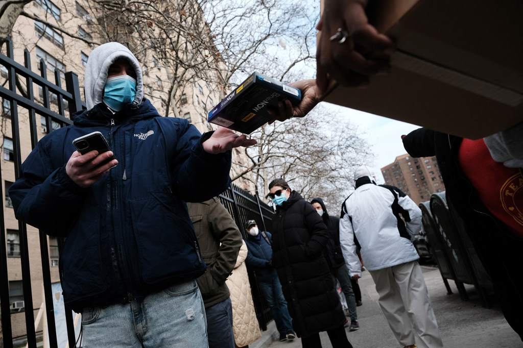 City workers hand out take-home Covid-19 test kits in lower Manhattan on December 23, 2021.