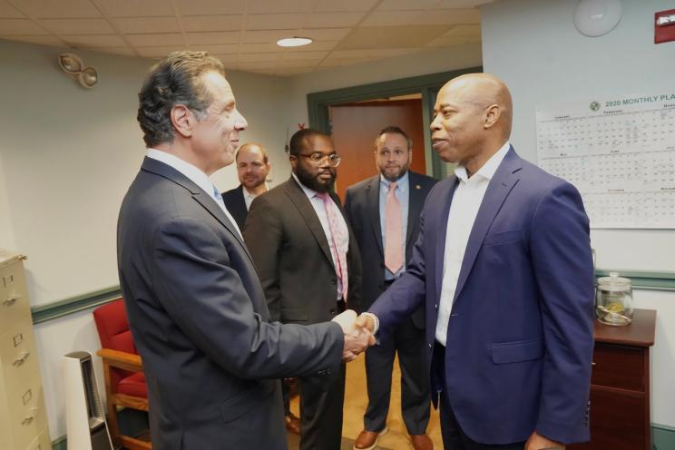 Adams shakes hands with Cuomo during a press conference in Jul. 2021.