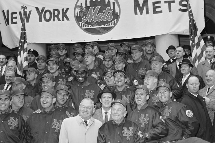 (Original Caption) The New York Mets' new National League baseball team, poses on the steps of City Hall April 12th, after they received a traditional ticker tape parade up Broadway. In front, wearing civilian clothes, is Mets' General Manager George Weiss, and to his right is the manager of the team, Casey Stengel.