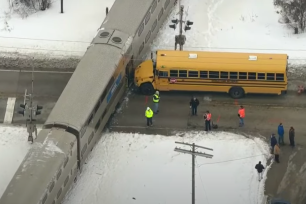 A school bus driver is being praised after safely evacuating five children on a school bus before it was struck by a Metra train.