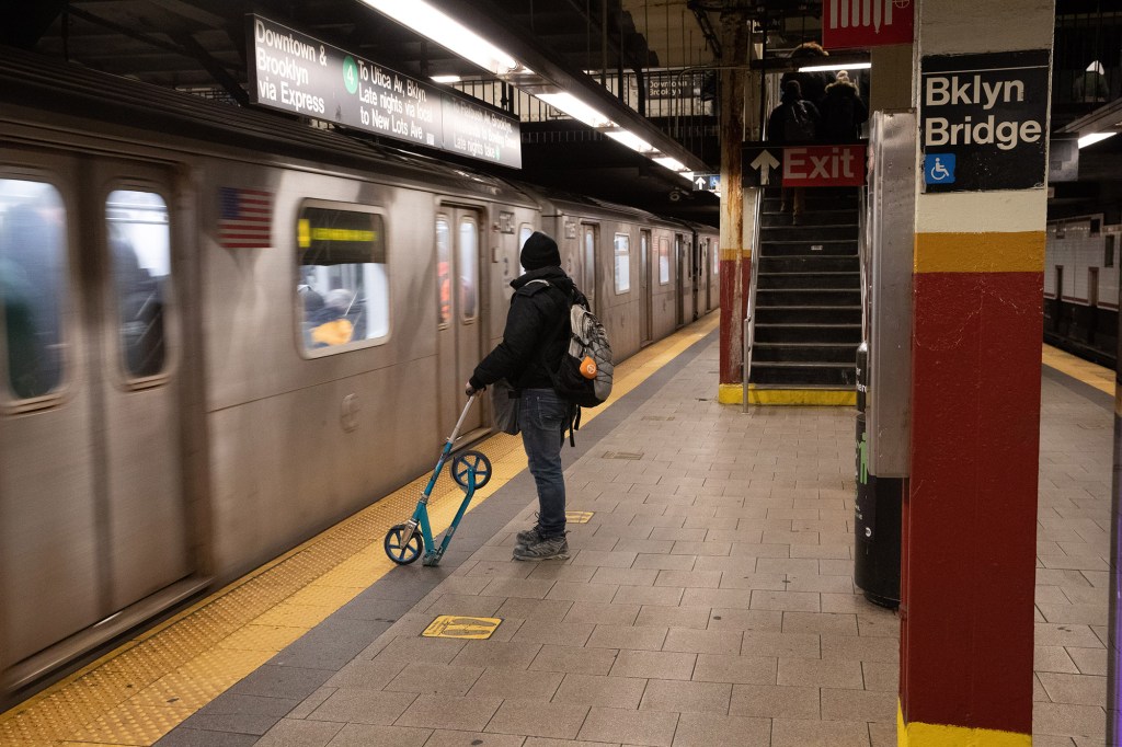 A man waits for the train in the City Hall subway station in Manhattan.