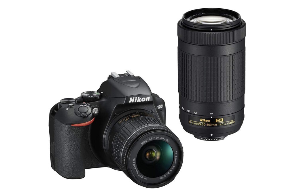 A black DSLR Nikon camera with a long lens 