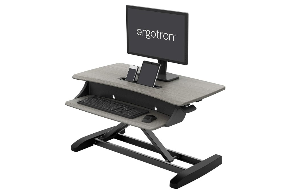 A standing desk convertor with a computer 