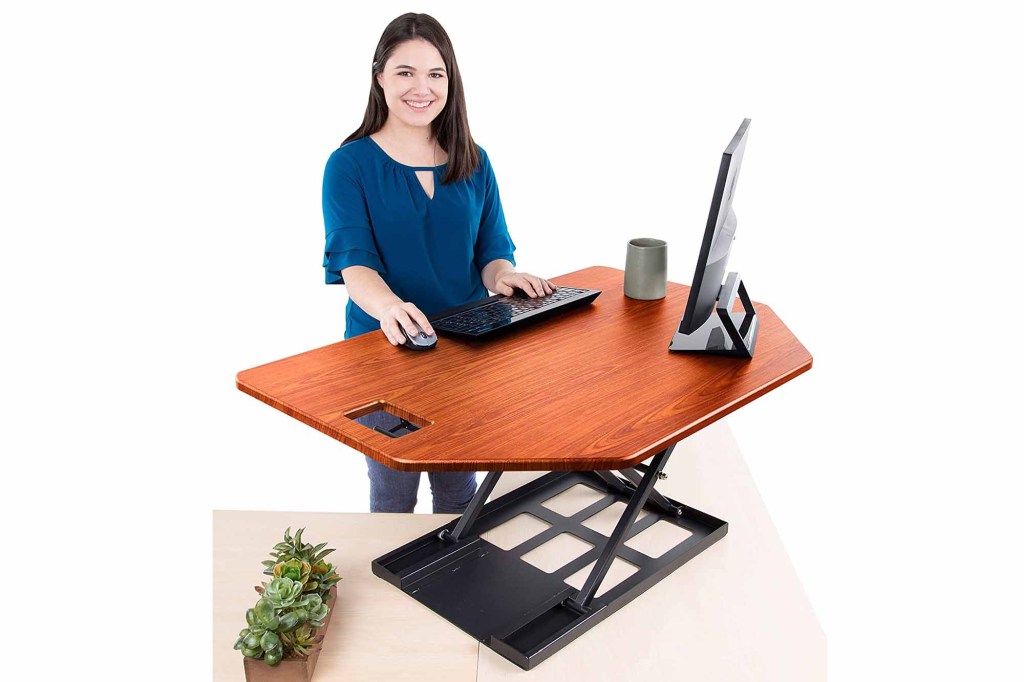 A woman standing at a desk 