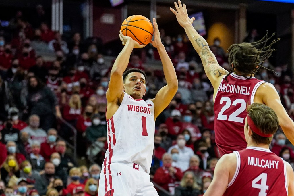 Wisconsin's Johnny Davis (1) shoots against Rutgers' Caleb McConnell (22) during the second half of an NCAA college basketball game Saturday, Feb. 12, 2022, in Madison, Wis.