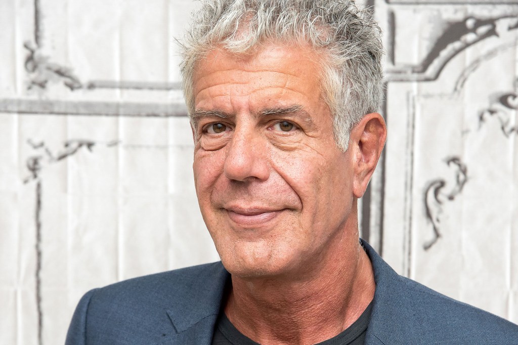 Anthony Bourdain in a gray jacket against a white background.