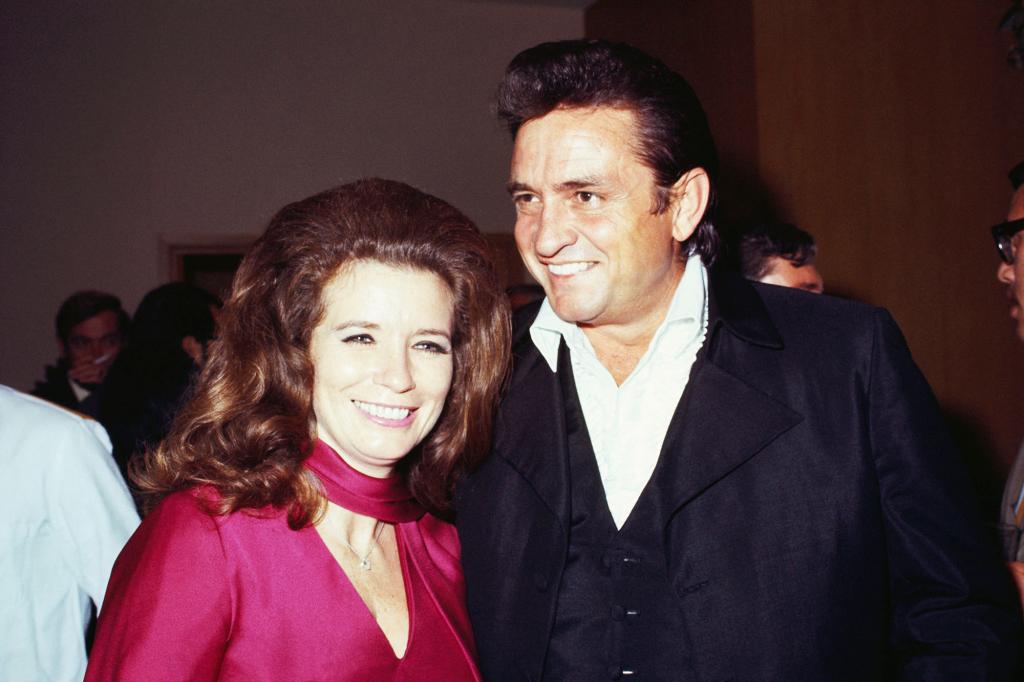 June Carter Cash in a pink dress and Johnny Cash in a black suit