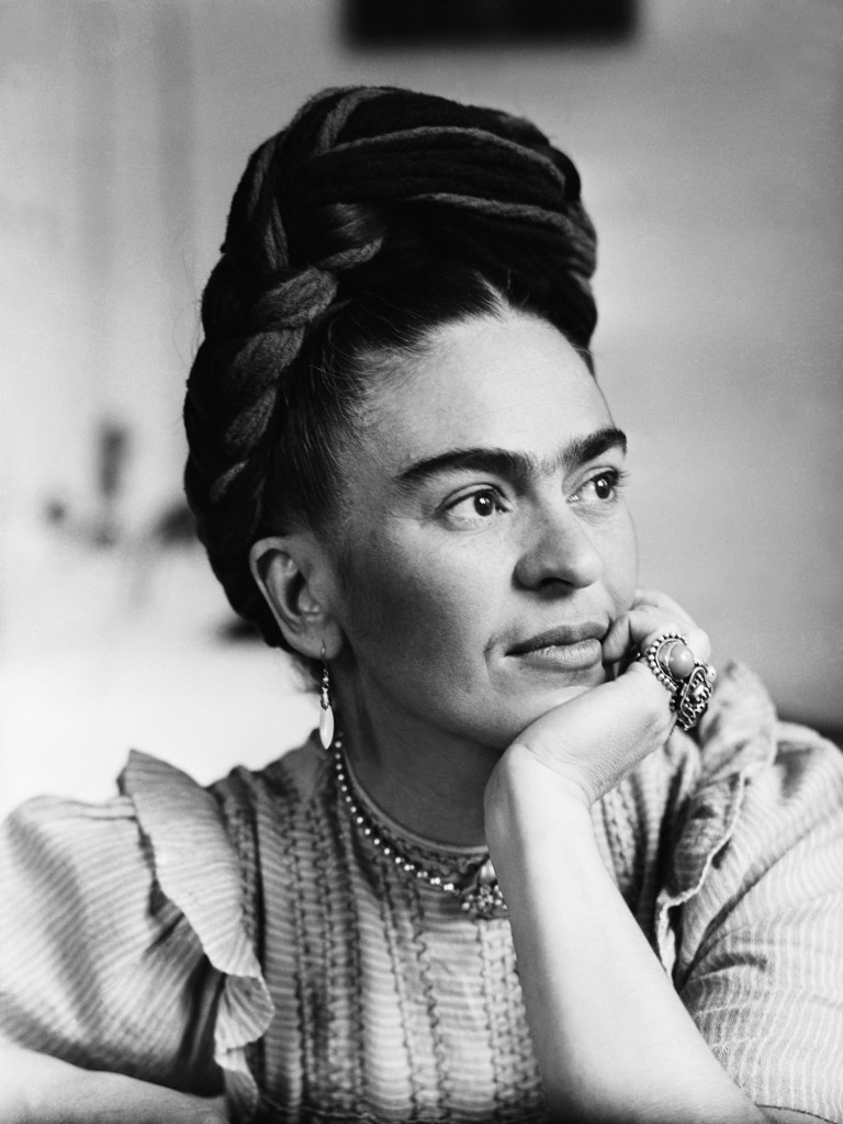 Black and white portrait of Frida Kahlo.