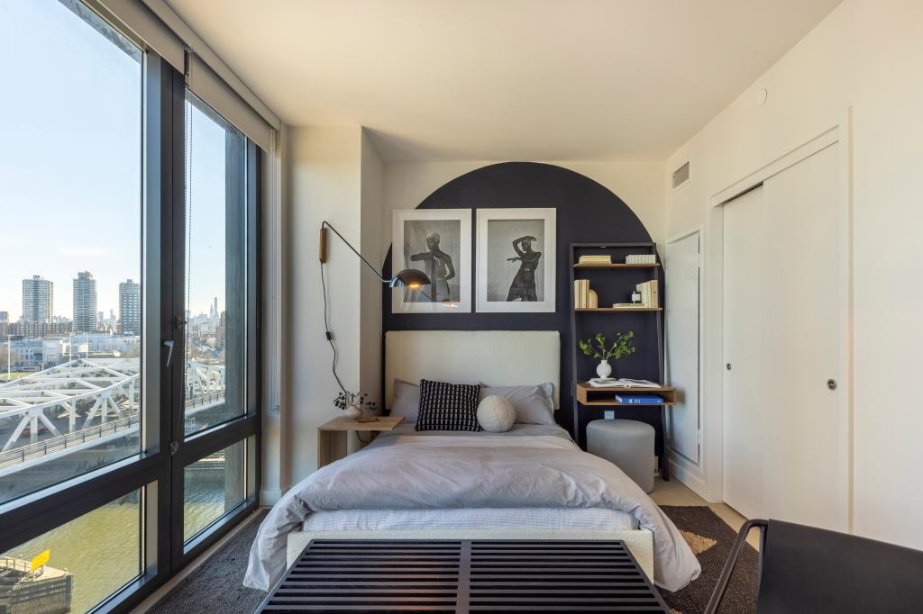 This bedroom has a view of the water.