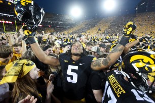 Jestin Jacobs #5 of the Iowa Hawkeyes celebrates with fans after the match-up against the Penn State.