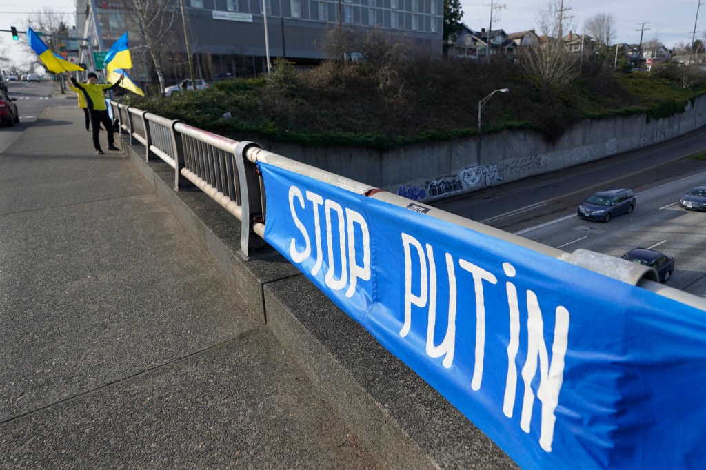 Demonstrator waves Ukrainian flags