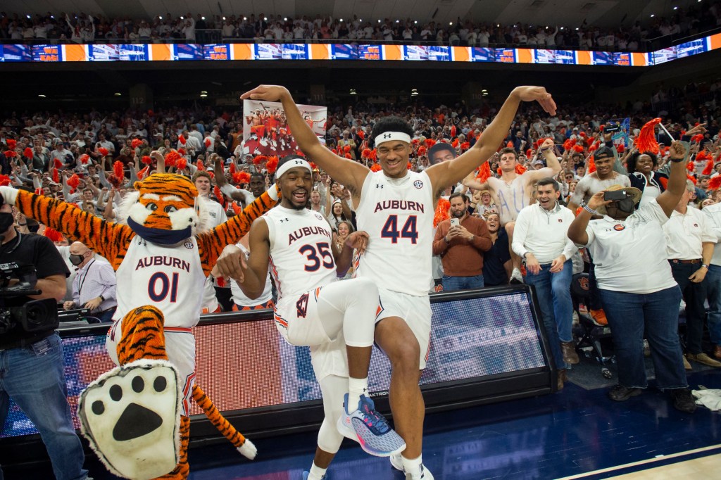 Devan Cambridge #35, Dylan Cardwell #44 of the Auburn Tigers and mascot Aubie celebrate after defeating the Alabama Crimson Tide.