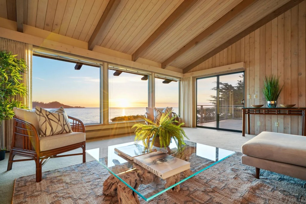 A living room with floor-to-ceiling windows to allow natural sunlight.