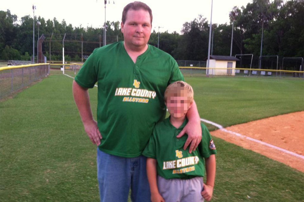 Bobby Matheny, 42, poses with child on baseball field