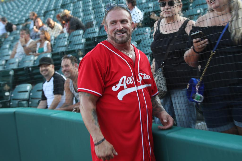 Frank Catania wears a red baseball jersey.