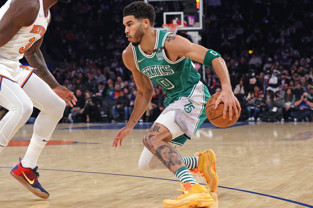 Julius Randle #30 of the New York Knicks defends against Jayson Tatum #0 of the Boston Celtics during the first quarter.