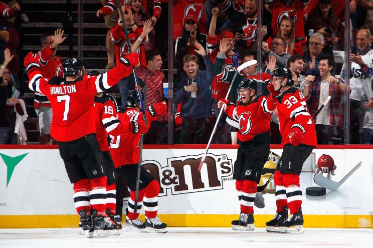 Andreas Johnsson #11 of the New Jersey Devils (2nd from right) celebrates his third period goal against the Chicago Blackhawks.