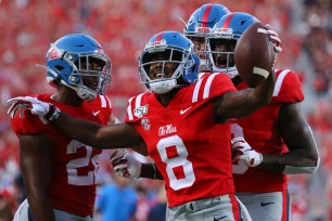 Elijah Moore #8 of the Mississippi Rebels celebrates a touchdown